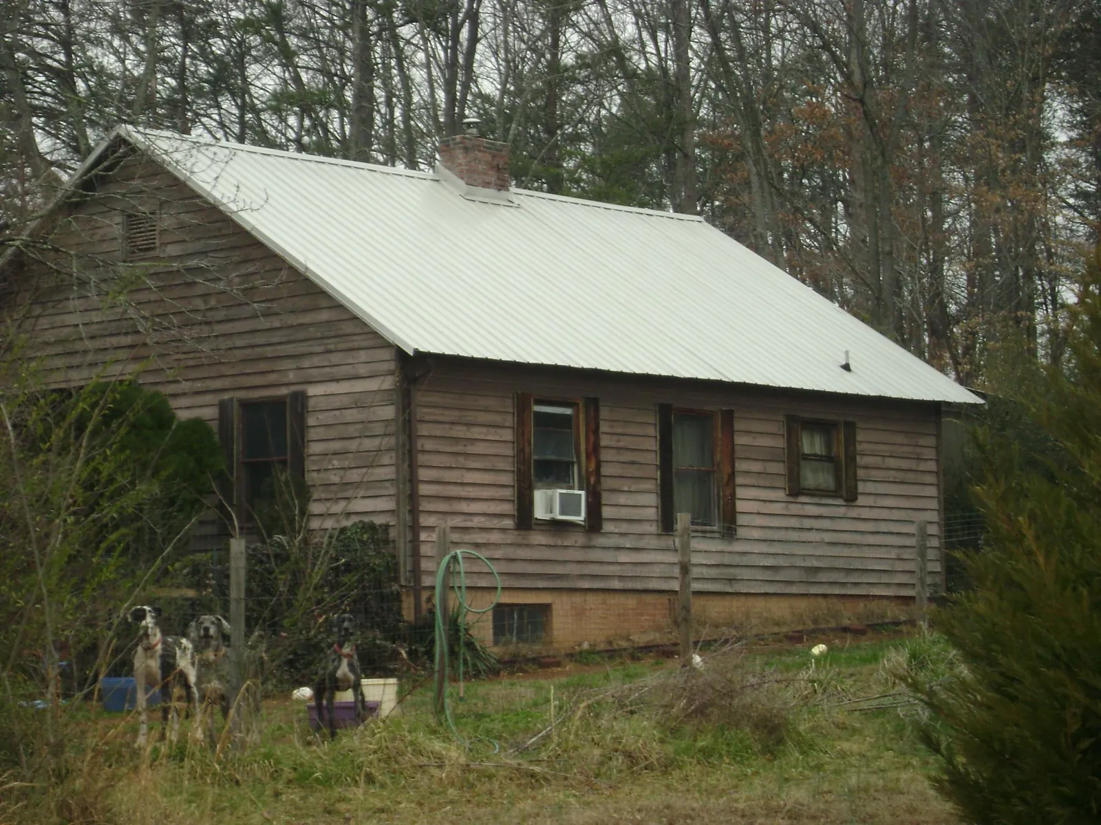 White metal roof on an old wood sided farmhouse, from a Metal Roof Installation job in Rutledge
